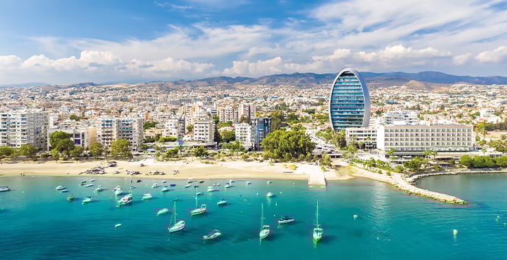 An aerial view of  Limassol Cyprus showing the coastline, marina, and cityscape with a modern high-rise building